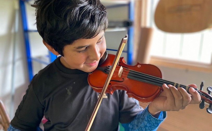 Noe plays violin Valle La Paz Foundation